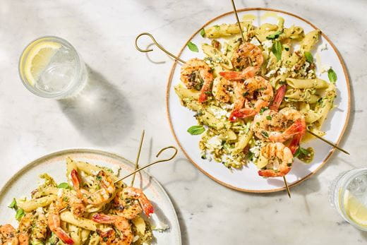 recipe image Herby prawn skewers with courgette, feta & mint pesto pasta salad